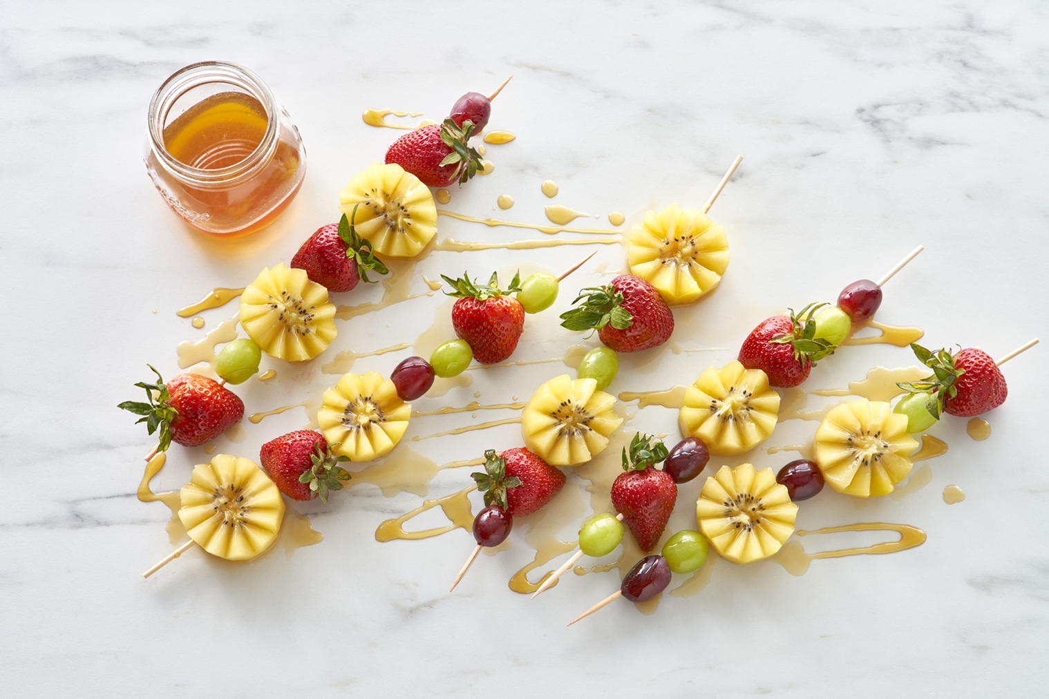 Zespri SunGold kiwi, strawberry and grape skewers with honey drizzle