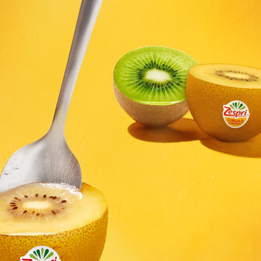 Spooning a zespri sungold kiwifruit