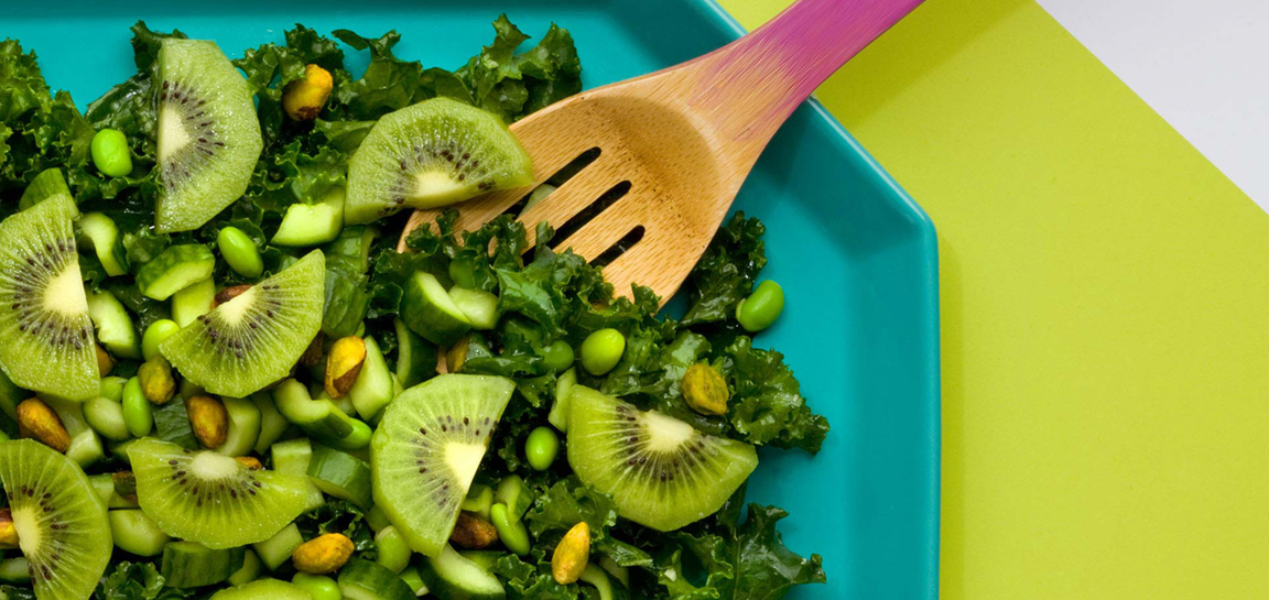 eafy kale salad with green kiwifruit, cucumber, edamame and pistachios